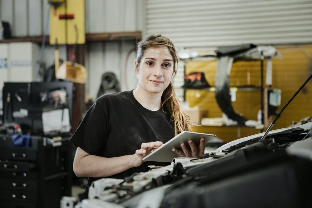 Happy female car mechanic