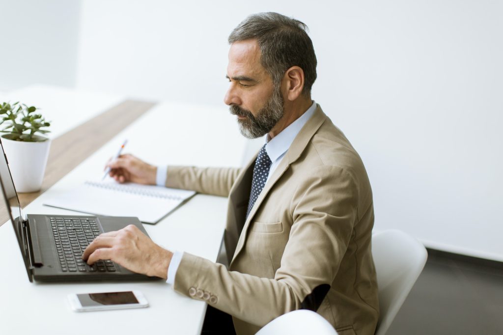 man at desk with computer