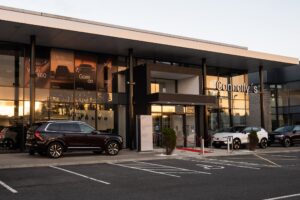 Cars outside a Volvo dealership.