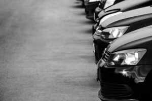 A lineup of a fleet of black cars.